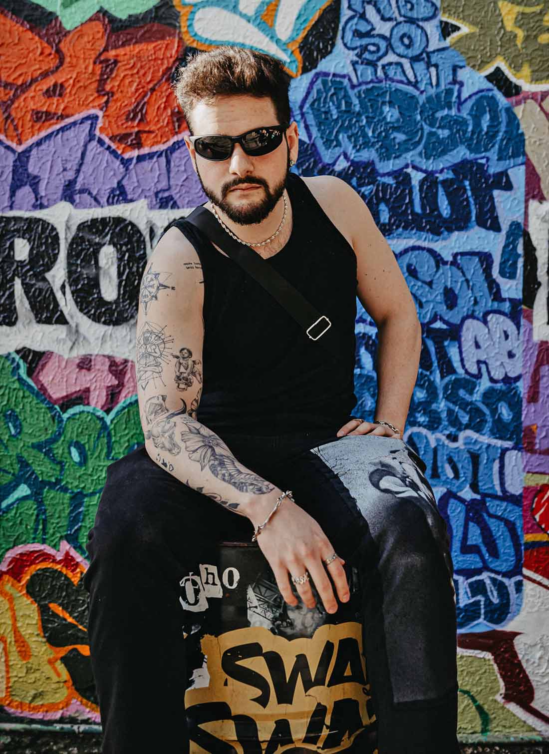 Man with Sunglasses and Tattooed Arm