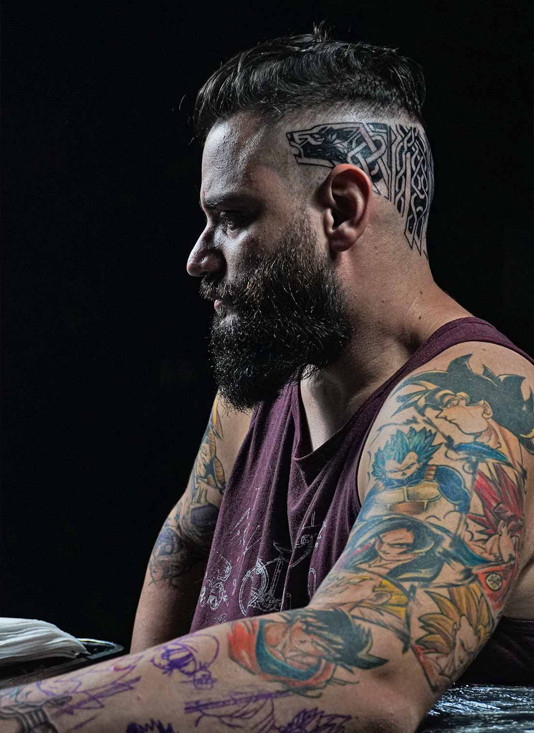 Person with Tattoos on Arms and back of the Head