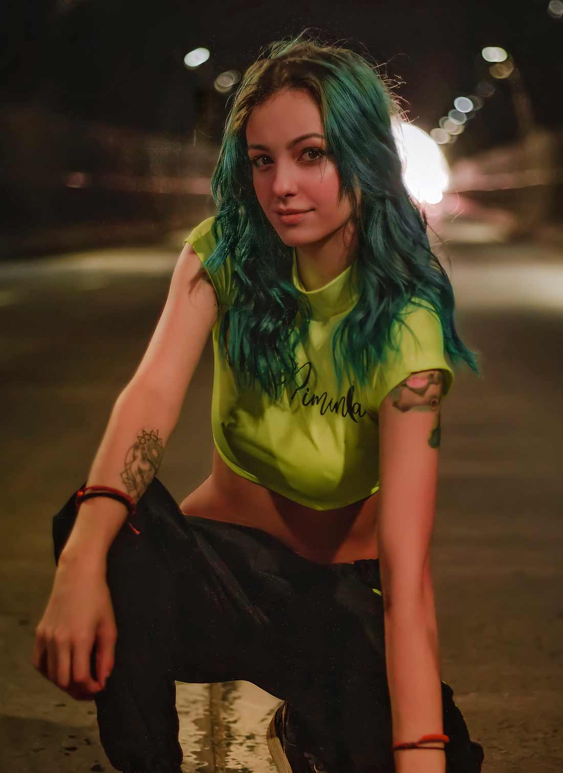 Woman with Green Hair and Tatoos on her Arms