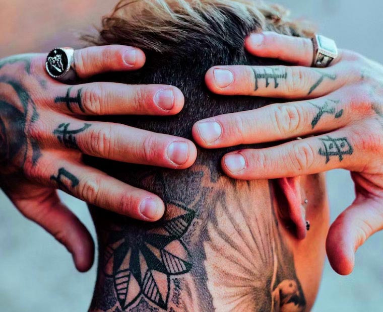 Man with Tattoo in the back of the neck and Hands