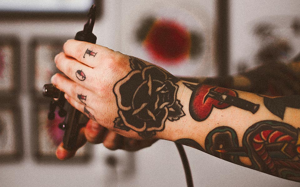 Person with Tattoos on Hand and Arm