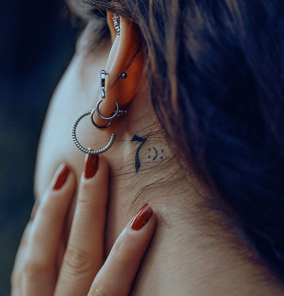 Woman with Small Tattoo Behind Ear