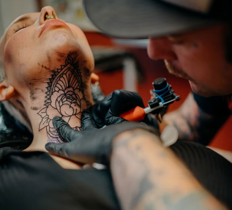 Person Getting a Tattoo in the Neck